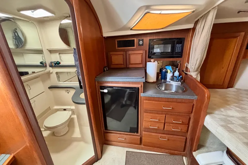  Yacht Photos Pics 2002 Luhrs 32 Open yacht interior with kitchenette and bathroom.