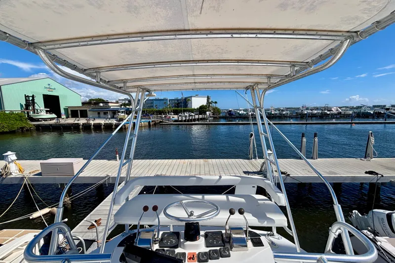  Yacht Photos Pics 2002 Luhrs 32 Open boat docked at a marina with clear blue skies.
