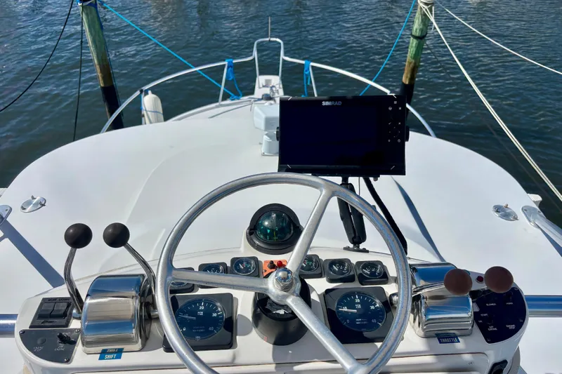 Yacht Photos Pics Helm of 2002 Luhrs 32 Open boat with steering wheel and navigation equipment.