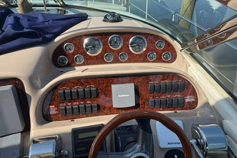  Yacht Photos Pics 2002 Sea Ray 360 Sundancer dashboard with gauges, switches, and Raytheon navigation system.