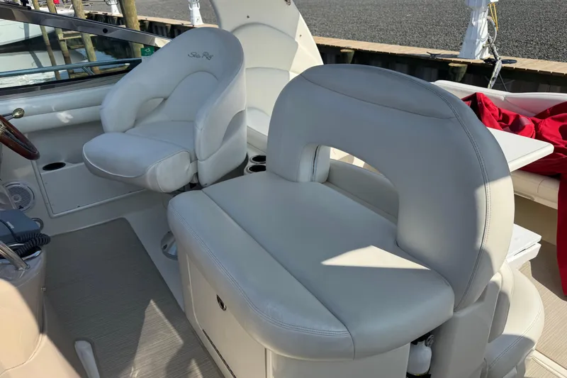  Yacht Photos Pics 2002 Sea Ray 360 Sundancer cockpit with white leather seating and steering wheel.