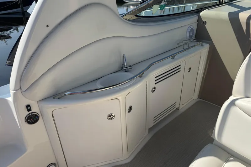  Yacht Photos Pics 2002 Sea Ray 360 Sundancer boat interior with sink and storage cabinets.