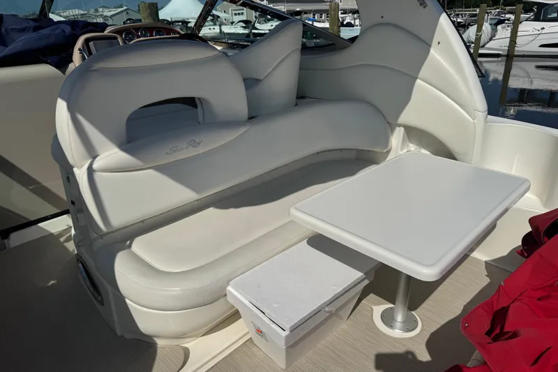  Yacht Photos Pics 2002 Sea Ray 360 Sundancer interior with white seating and table, docked at marina.