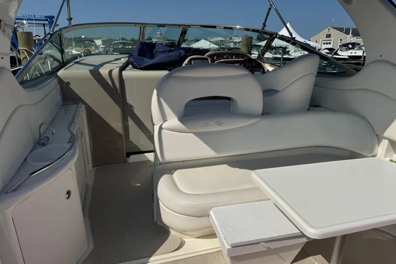  Yacht Photos Pics 2002 Sea Ray 360 Sundancer interior with white seating, table, and compact kitchenette.