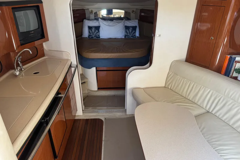  Yacht Photos Pics Interior of 2002 Sea Ray 360 Sundancer with kitchenette, seating, and sleeping area.