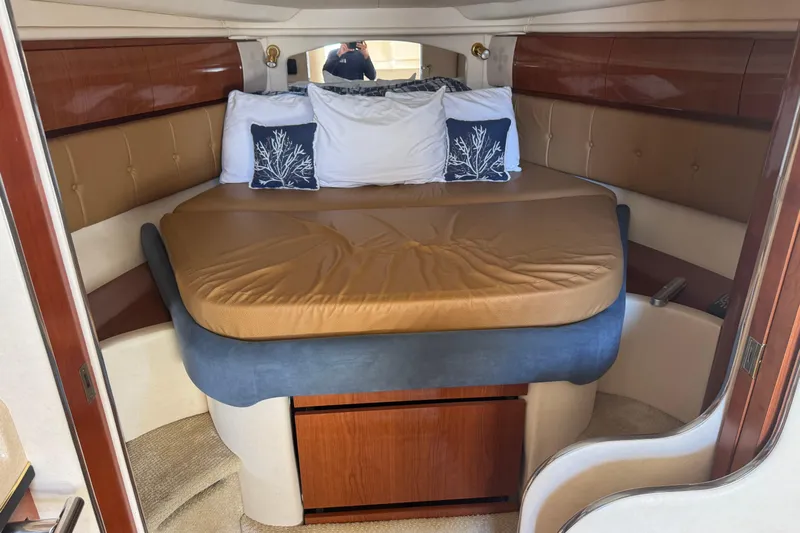  Yacht Photos Pics Luxurious cabin interior of 2002 Sea Ray 360 Sundancer with cozy bed and elegant decor.