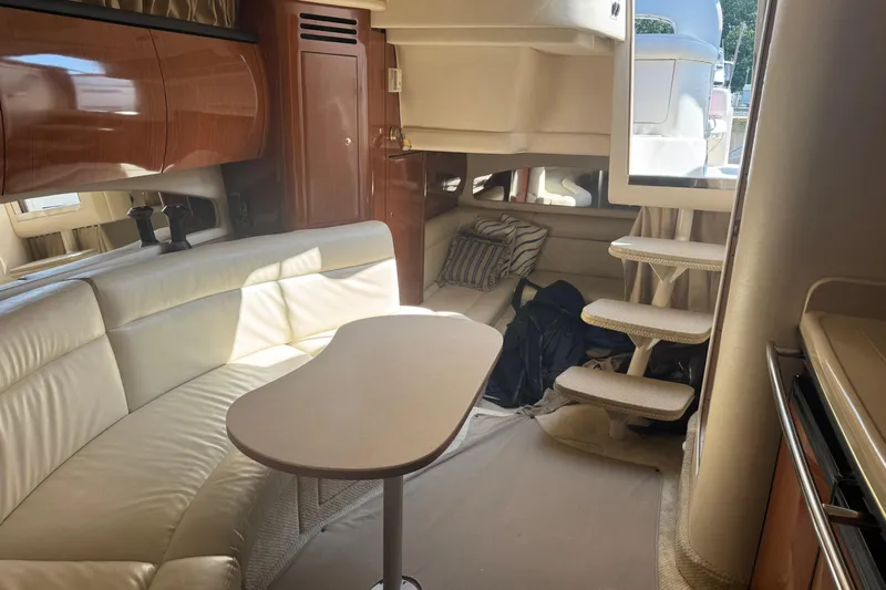  Yacht Photos Pics Interior of 2002 Sea Ray 360 Sundancer yacht with cream leather seating and wooden cabinetry.
