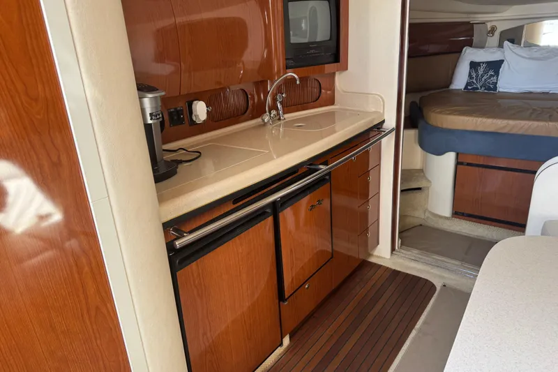 Yacht Photos Pics 2002 Sea Ray 360 Sundancer interior with kitchenette and cozy sleeping area.