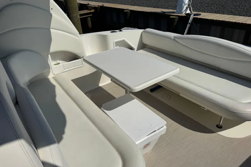  Yacht Photos Pics Interior seating area of a 2002 Sea Ray 360 Sundancer boat with white upholstery.
