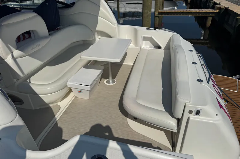  Yacht Photos Pics 2002 Sea Ray 360 Sundancer boat interior with seating and table by the dock.