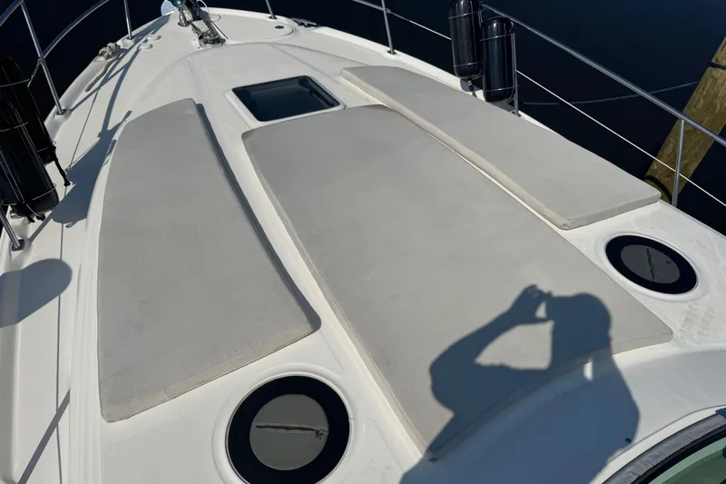  Yacht Photos Pics 2002 Sea Ray 360 Sundancer deck with sun pads and railing, shadow visible.