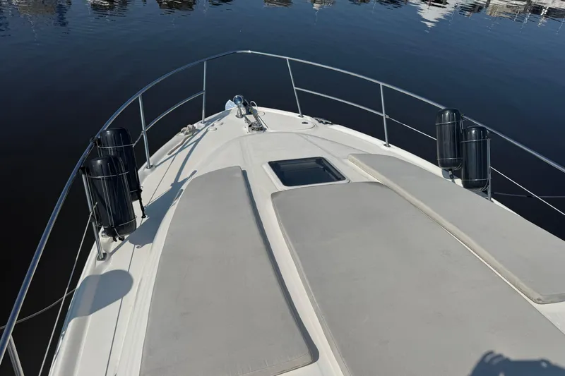  Yacht Photos Pics Bow view of 2002 Sea Ray 360 Sundancer yacht with sun pads and railings.