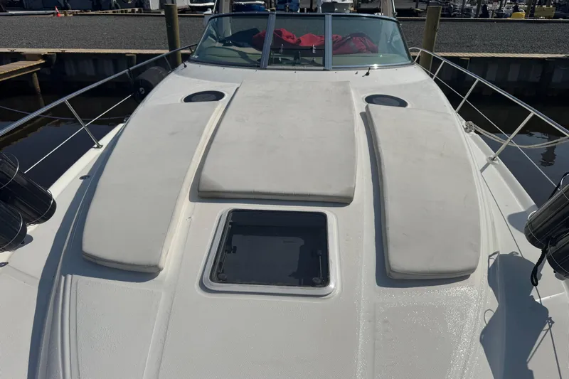  Yacht Photos Pics 2002 Sea Ray 360 Sundancer boat deck with sun pads and hatch, docked at marina.