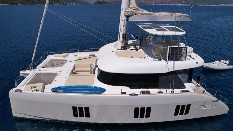 Welcome Back Yacht Photos Pics Luxurious 2019 Sunreef 50 catamaran sailing on serene blue waters.