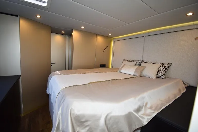 Welcome Back Yacht Photos Pics Luxurious bedroom interior of 2019 Sunreef 50 yacht with elegant bedding and modern lighting.
