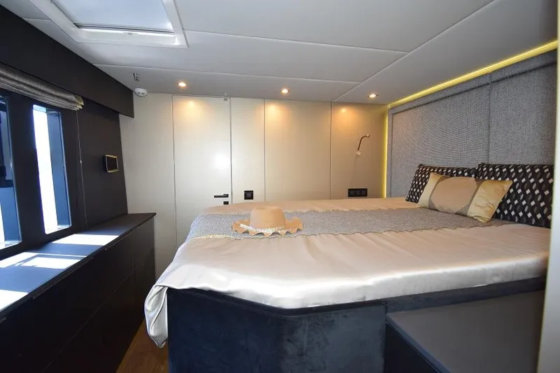 Welcome Back Yacht Photos Pics Luxurious bedroom interior of 2019 Sunreef 50 yacht with elegant bedding and modern lighting.