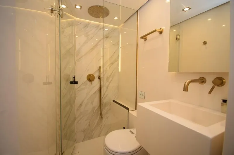 Welcome Back Yacht Photos Pics Luxurious bathroom in 2019 Sunreef 50 yacht with modern fixtures and marble accents.