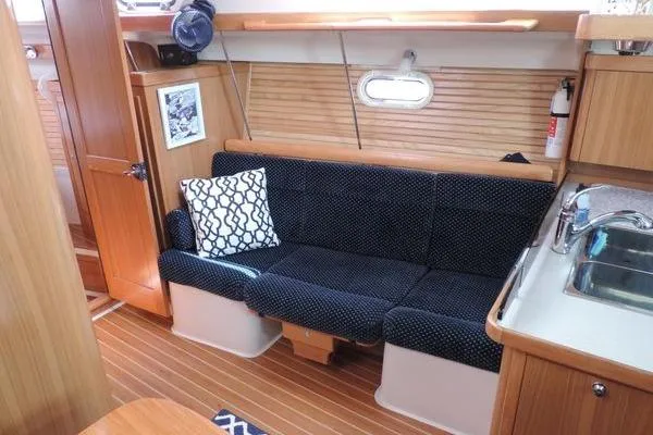 Eighth Day Yacht Photos Pics Interior of 2008 Catalina 350 MkII sailboat with cozy seating and wooden finishes.