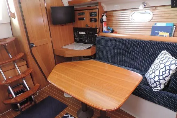 Eighth Day Yacht Photos Pics 2008 Catalina 350 MkII interior with wooden table, seating, and navigation equipment.