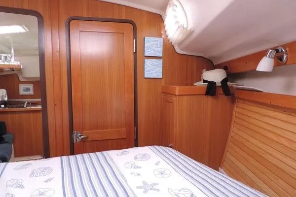 Eighth Day Yacht Photos Pics Interior of 2008 Catalina 350 MkII sailboat with wood paneling and cozy cabin.