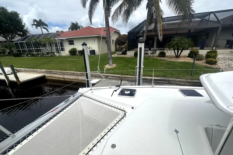  Yacht Photos Pics Leopard 44 catamaran docked near waterfront home with palm trees, 2016 model.