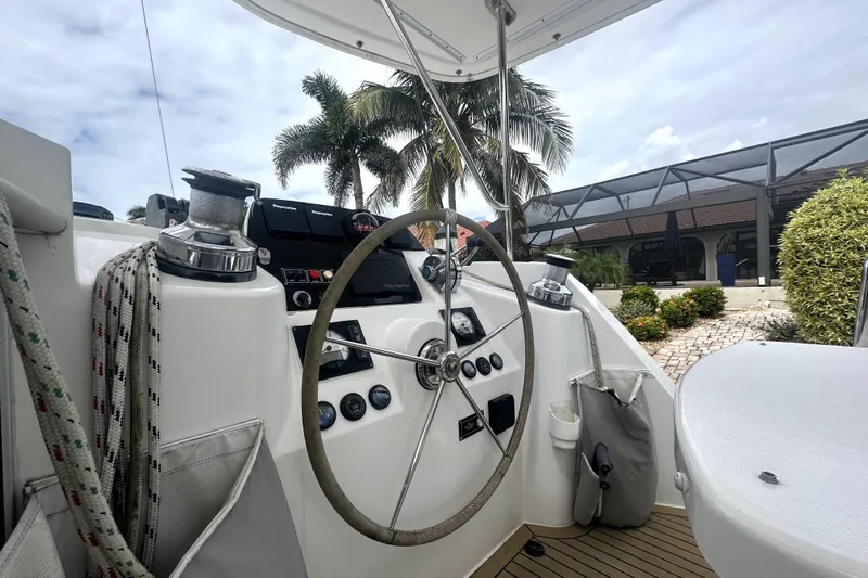  Yacht Photos Pics Helm of 2016 Leopard 44 catamaran with steering wheel and navigation controls.