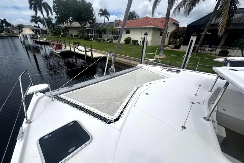  Yacht Photos Pics Catamaran Leopard 44 (2016) docked by waterfront homes with palm trees.