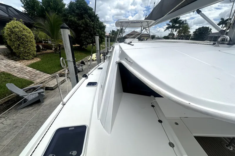  Yacht Photos Pics 2016 Leopard 44 catamaran docked, showcasing sleek deck design and lush surroundings.