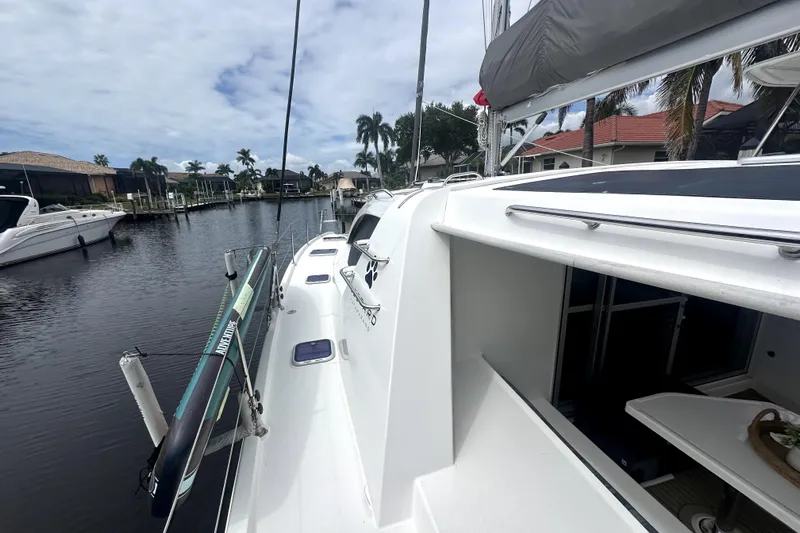  Yacht Photos Pics 2016 Leopard 44 catamaran docked in a scenic marina with palm trees.