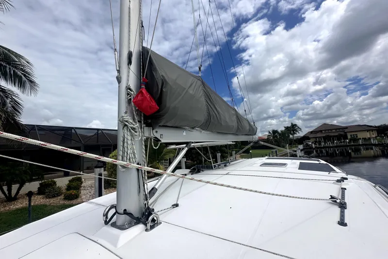  Yacht Photos Pics 2016 Leopard 44 catamaran with covered sails docked under a cloudy sky.