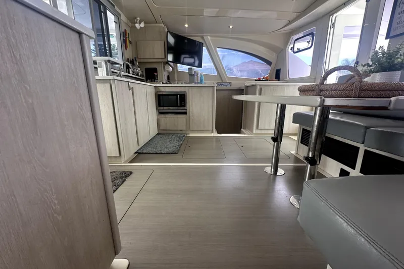  Yacht Photos Pics Modern interior of 2016 Leopard 44 catamaran with kitchen and dining area.