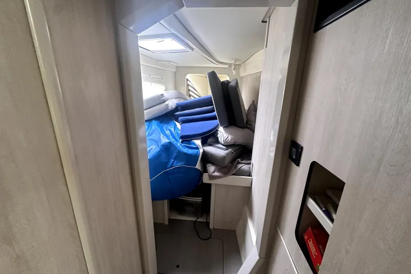  Yacht Photos Pics Interior of a 2016 Leopard 44 yacht with stacked cushions and storage space.