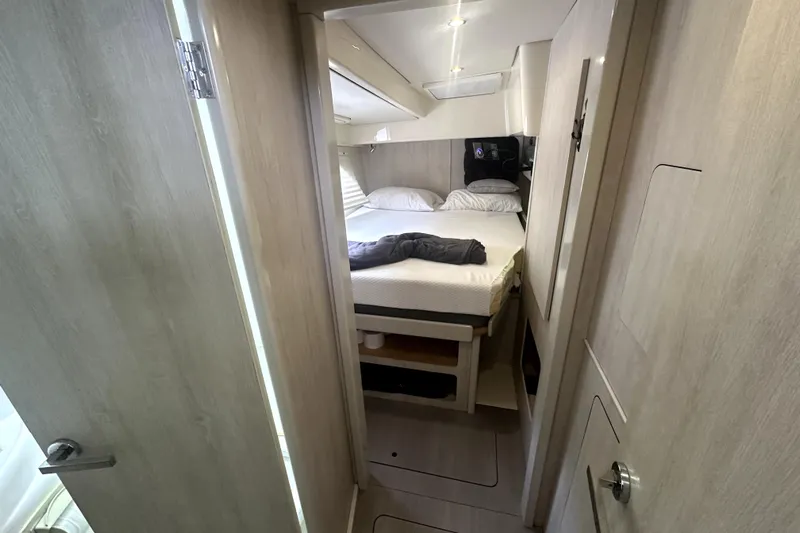  Yacht Photos Pics Cozy bedroom interior of 2016 Leopard 44 yacht with modern design and soft lighting.