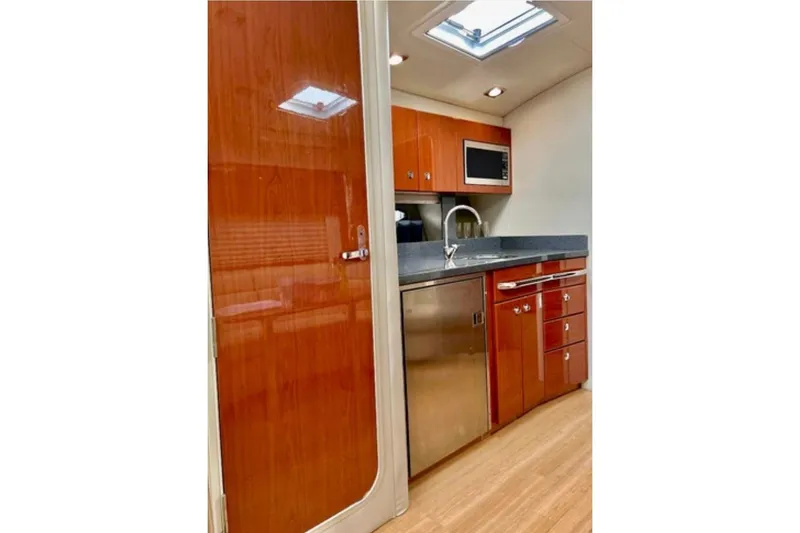  Yacht Photos Pics 2011 Formula 37 PC yacht interior kitchen with wood cabinetry and stainless steel appliances.