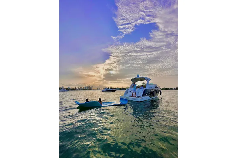  Yacht Photos Pics 2011 Formula 37 PC yacht on serene water at sunset with vibrant sky.
