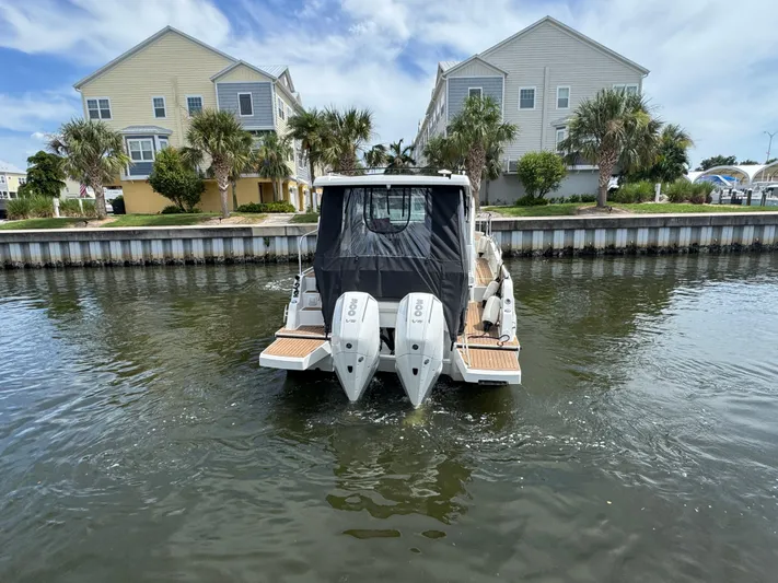  Yacht Photos Pics 2024 Beneteau Antares 11 boat with dual engines on a calm waterway.
