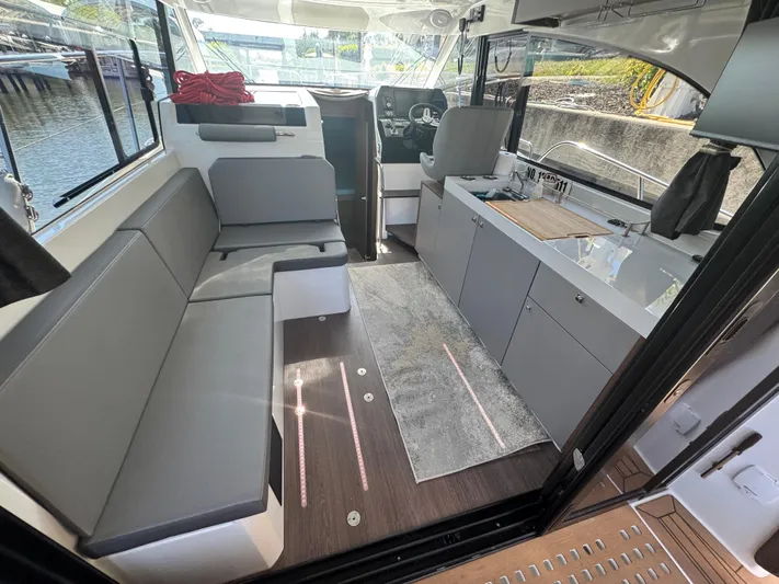  Yacht Photos Pics Interior of 2024 Beneteau Antares 11, featuring modern seating and sleek kitchen area.