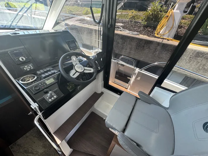  Yacht Photos Pics 2024 Beneteau Antares 11 helm with modern controls and comfortable seating.