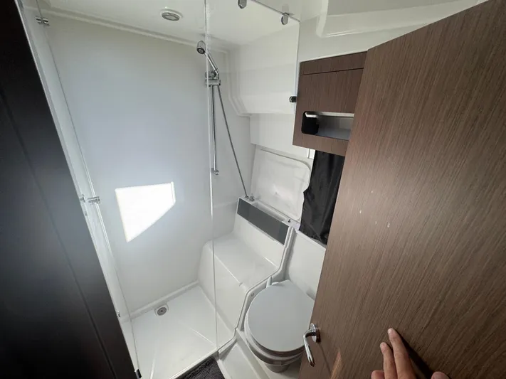  Yacht Photos Pics 2024 Beneteau Antares 11 bathroom with modern fixtures and wooden accents.