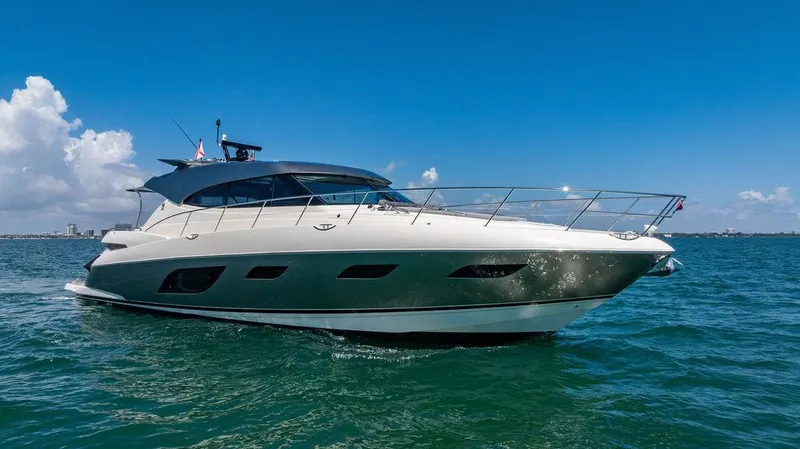 Bald Eagle Yacht Photos Pics 2024 Riviera 6000SY yacht cruising on open water under clear blue skies.