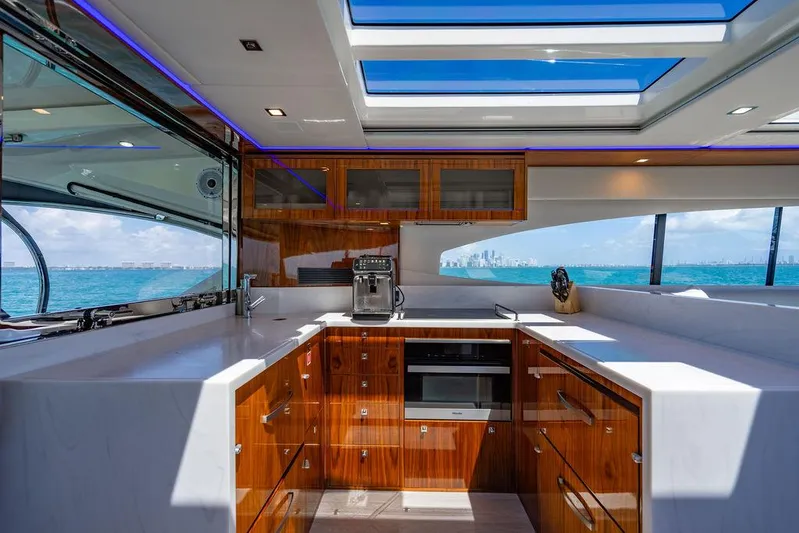 Bald Eagle Yacht Photos Pics Luxurious kitchen interior of 2024 Riviera 6000SY yacht with ocean view and modern amenities.