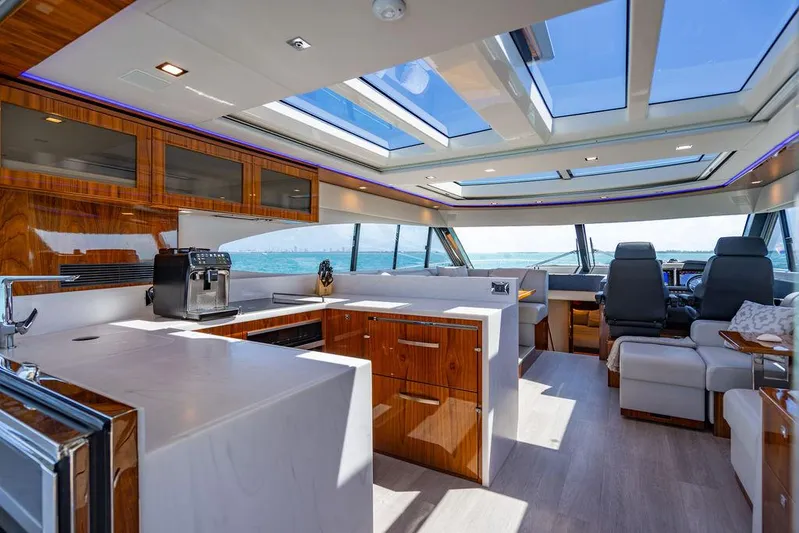 Bald Eagle Yacht Photos Pics Luxurious interior of 2024 Riviera 6000SY yacht with modern kitchen and panoramic windows.