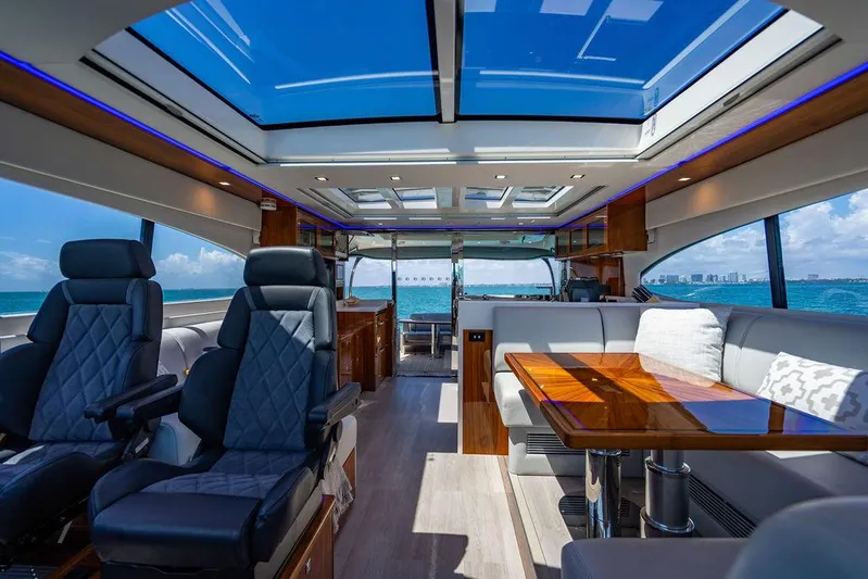 Bald Eagle Yacht Photos Pics Luxurious interior of 2024 Riviera 6000SY yacht with panoramic windows and elegant seating.
