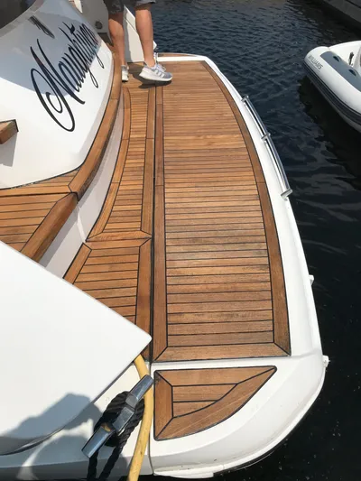  Yacht Photos Pics 2021 Fairline Targa 45 GT yacht with teak deck, docked by the water.