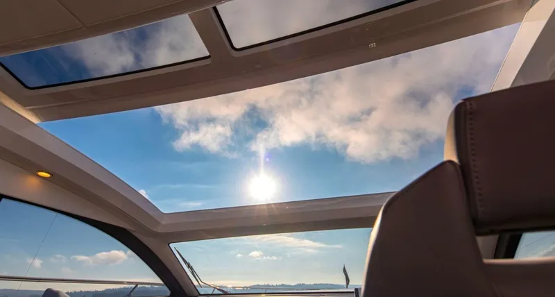  Yacht Photos Pics Sunlight through sunroof of 2021 Fairline Targa 45 GT yacht, clear sky view.