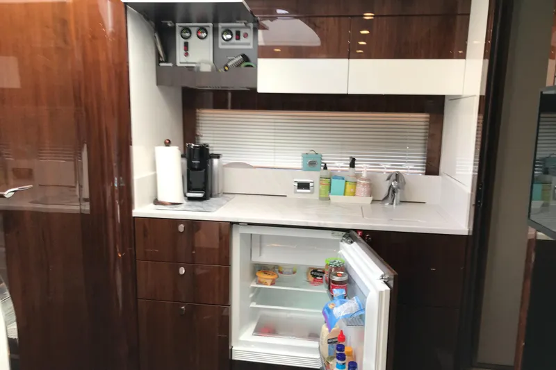  Yacht Photos Pics Modern kitchen in 2021 Fairline Targa 45 GT yacht with open fridge and sleek cabinetry.