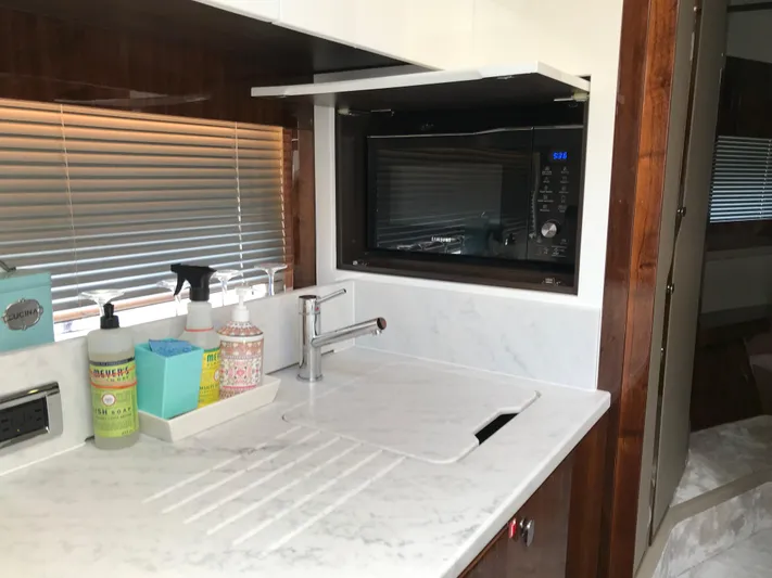  Yacht Photos Pics Modern kitchen area in 2021 Fairline Targa 45 GT yacht with sink and microwave.