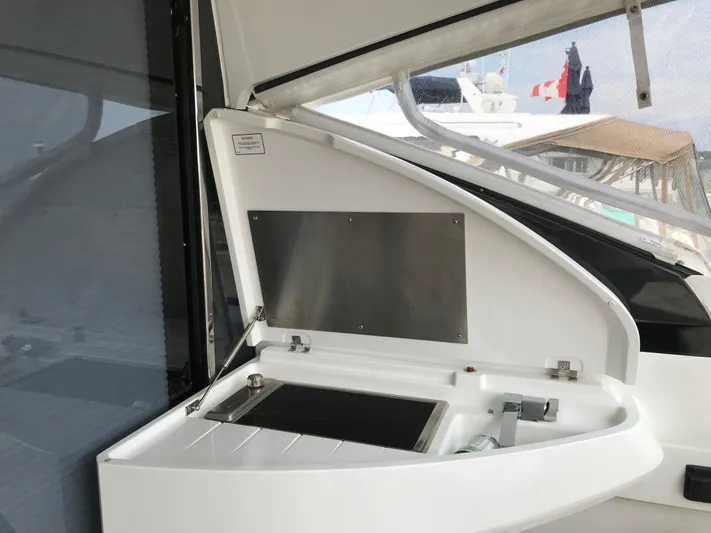  Yacht Photos Pics 2021 Fairline Targa 45 GT yacht interior detail with open storage compartment.