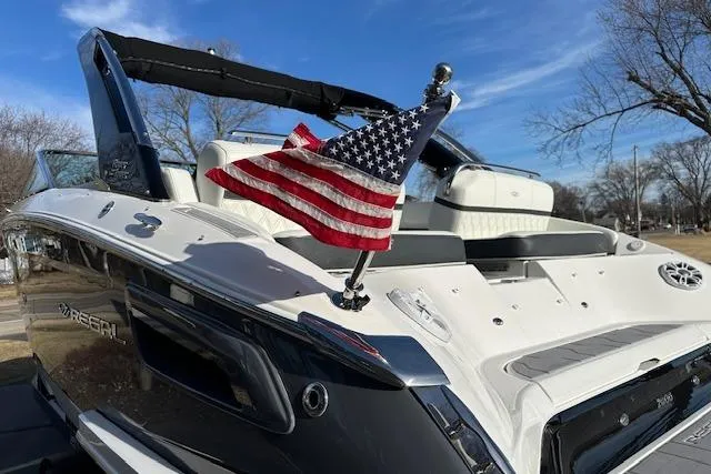  Yacht Photos Pics 2023 Regal 2800 Bowrider boat with American flag, sleek design, and luxurious seating.