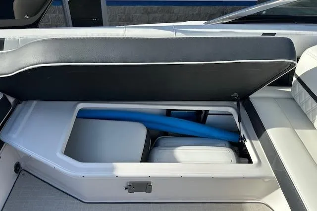  Yacht Photos Pics 2023 Regal 2800 Bowrider storage compartment with blue pool noodle and cooler.